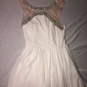White beaded mini dress with nude mesh straps.